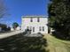 Home back exterior with a patio area, level backyard, and light gray siding at 7036 Barlows Knoll St, Raleigh, NC 27610
