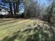 A backyard with a grass lawn, trees, and plenty of space for outdoor activities at 7036 Barlows Knoll St, Raleigh, NC 27610