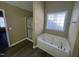 Bright bathroom featuring a separate glass enclosed shower and a separate soaking tub at 7036 Barlows Knoll St, Raleigh, NC 27610