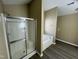 Bathroom featuring a glass-enclosed shower and a separate soaking tub on dark wood-look floors at 7036 Barlows Knoll St, Raleigh, NC 27610