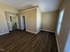 This bedroom showcases dark wood-look floors and neutral walls, offering a serene and adaptable space at 7036 Barlows Knoll St, Raleigh, NC 27610