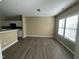Bright dining area with modern floors and natural light, adjacent to a partial wall with kitchen access at 7036 Barlows Knoll St, Raleigh, NC 27610