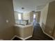 Upstairs hallway with hardwood floors and a staircase featuring a white wood banister at 7036 Barlows Knoll St, Raleigh, NC 27610