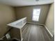 Upstairs landing with hardwood floors, natural light, and a view of the staircase and hallway at 7036 Barlows Knoll St, Raleigh, NC 27610