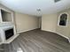 Spacious living room featuring modern flooring, neutral walls, and a cozy fireplace with detailed moulding at 7036 Barlows Knoll St, Raleigh, NC 27610