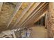 Unfinished attic space with exposed beams, wood sheathing, and some building supplies at 75 Morgan Dr, Lillington, NC 27546