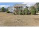 Exterior shot of the house from the backyard featuring a screened porch with fans at 75 Morgan Dr, Lillington, NC 27546