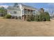 Spacious backyard view of the home featuring a screened porch and mature landscaping at 75 Morgan Dr, Lillington, NC 27546