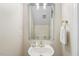 Charming powder room features an oval sink, stylish mirror and brushed gold hardware at 75 Morgan Dr, Lillington, NC 27546