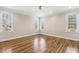Spacious bedroom with hardwood floors, a ceiling fan, neutral walls, and natural light at 75 Morgan Dr, Lillington, NC 27546