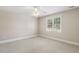 Bright bedroom featuring a ceiling fan, neutral walls, and a window offering natural light at 75 Morgan Dr, Lillington, NC 27546