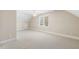 An attic bedroom with neutral colors, a ceiling fan, and a window at 75 Morgan Dr, Lillington, NC 27546