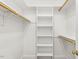 Walk-in closet with built-in shelving and closet rods at 75 Morgan Dr, Lillington, NC 27546