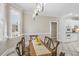 The dining room features a rustic table, tile floors, and natural light from the window at 75 Morgan Dr, Lillington, NC 27546