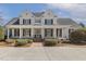Beautiful white two-story home with black shutters, large front porch, and landscaped yard at 75 Morgan Dr, Lillington, NC 27546