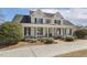 Expansive two-story home with a wide front porch, white columns and black shutters at 75 Morgan Dr, Lillington, NC 27546