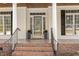 Inviting front porch with brick steps, stately columns, and classic shutters at 75 Morgan Dr, Lillington, NC 27546
