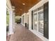 Charming front porch with brick flooring, white columns and black shutters at 75 Morgan Dr, Lillington, NC 27546