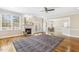 Sunlit living room with a marble fireplace, hardwood floors, and access to the back porch at 75 Morgan Dr, Lillington, NC 27546