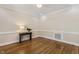 Bright room with hardwood floors, elegant trim, and a console table with decorative lamp at 75 Morgan Dr, Lillington, NC 27546