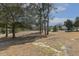 View of the lawn with mature trees enhancing the landscape around the property at 75 Morgan Dr, Lillington, NC 27546