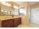 Bathroom featuring dual sinks, granite countertops, custom vanity, and a glass-enclosed shower at 836 Canyoncreek Ln, Fuquay Varina, NC 27526