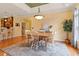 Bright dining area showcases a wood table, neutral walls, and a large window letting in natural light at 836 Canyoncreek Ln, Fuquay Varina, NC 27526