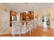Open-concept kitchen featuring granite countertops, modern appliances, bar seating, and hardwood floors at 836 Canyoncreek Ln, Fuquay Varina, NC 27526
