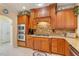 Well-equipped kitchen with granite countertops, stainless steel appliances, wood cabinets, and a stone backsplash at 836 Canyoncreek Ln, Fuquay Varina, NC 27526