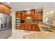 Spacious kitchen boasts granite counters, stone backsplash, stainless appliances, and ample wood cabinetry at 836 Canyoncreek Ln, Fuquay Varina, NC 27526