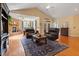 Bright living room with a stone fireplace, wood floors, and a large rug for a comfortable gathering space at 836 Canyoncreek Ln, Fuquay Varina, NC 27526