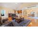 Inviting living area with wood floors, a leather sofa set, and seamless access to the kitchen and dining room at 836 Canyoncreek Ln, Fuquay Varina, NC 27526