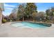 Beautiful pool with a waterfall feature and mature landscaping that enhances its privacy at 836 Canyoncreek Ln, Fuquay Varina, NC 27526