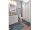 Cozy bathroom with a granite vanity top, framed mirror, and bathtub with shower at 103 1St St, Haw River, NC 27258