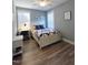Comfortable bedroom with a ceiling fan, and a desk area by the window at 103 1St St, Haw River, NC 27258
