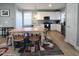 Open dining area with a wooden table, chairs, and stylish rug, adjacent to the kitchen at 103 1St St, Haw River, NC 27258