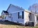 Exterior view of the home, highlighting the siding, windows, and well-maintained landscaping at 103 1St St, Haw River, NC 27258