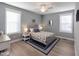 Bright main bedroom featuring a ceiling fan, large windows, and calming decor at 103 1St St, Haw River, NC 27258