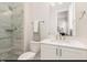 Modern bathroom featuring a glass-enclosed shower and sleek vanity with a white countertop at 123 Stone Park Dr, Wake Forest, NC 27587