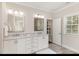 Bright bathroom with double vanity, white cabinets, and marble countertops at 123 Stone Park Dr, Wake Forest, NC 27587