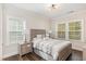 Comfortable bedroom with wood floors, and a large window offering natural light at 123 Stone Park Dr, Wake Forest, NC 27587