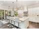 Bright, eat-in kitchen with white cabinets, stainless steel appliances, and a modern island with seating at 123 Stone Park Dr, Wake Forest, NC 27587