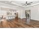 Spacious living area with hardwood floors, an open layout, and a view into the modern eat-in kitchen at 123 Stone Park Dr, Wake Forest, NC 27587