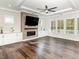 Bright living room featuring a fireplace, custom built-ins, and large windows with natural light at 123 Stone Park Dr, Wake Forest, NC 27587