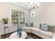 Comfortable living room featuring a sectional sofa, hardwood floors, and ample natural light through large windows at 123 Stone Park Dr, Wake Forest, NC 27587
