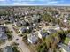 An aerial view of a neighborhood with tree-lined streets and well-maintained homes at 12409 Village Gate Way, Raleigh, NC 27614