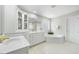 Bright primary bathroom features double sink vanity, a soaking tub, and plenty of storage at 12409 Village Gate Way, Raleigh, NC 27614