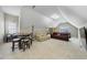 Spacious bonus room with a vaulted ceiling, cozy seating, and a game table at 12409 Village Gate Way, Raleigh, NC 27614