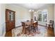 Formal dining room featuring wood table, chairs, hutch, and natural light from large windows at 12409 Village Gate Way, Raleigh, NC 27614