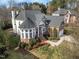 Aerial view of a beautifully landscaped two-story house with a brick facade and a three-car garage at 12409 Village Gate Way, Raleigh, NC 27614